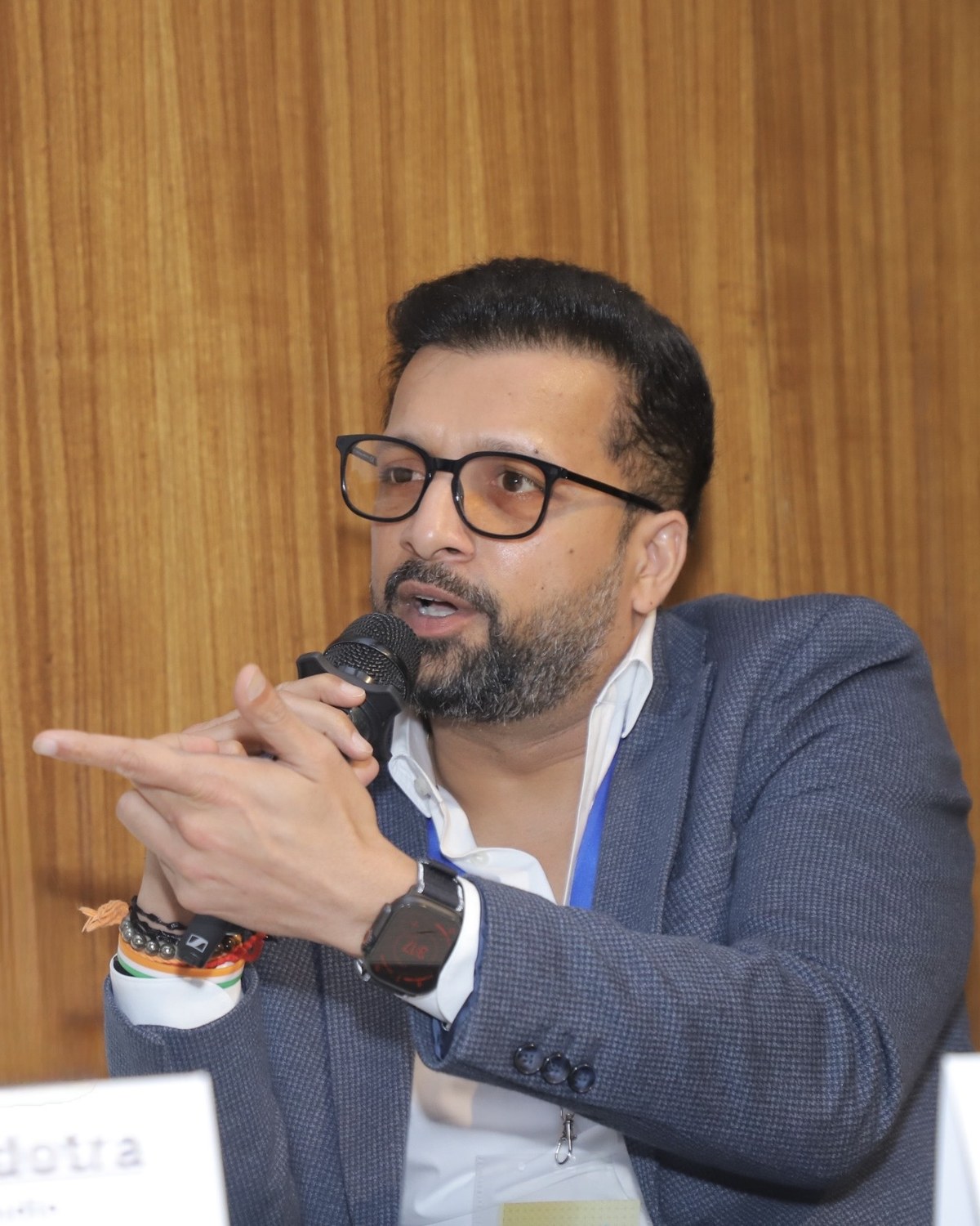 Sahil Jindal speaking into a microphone during an industry panel discussion